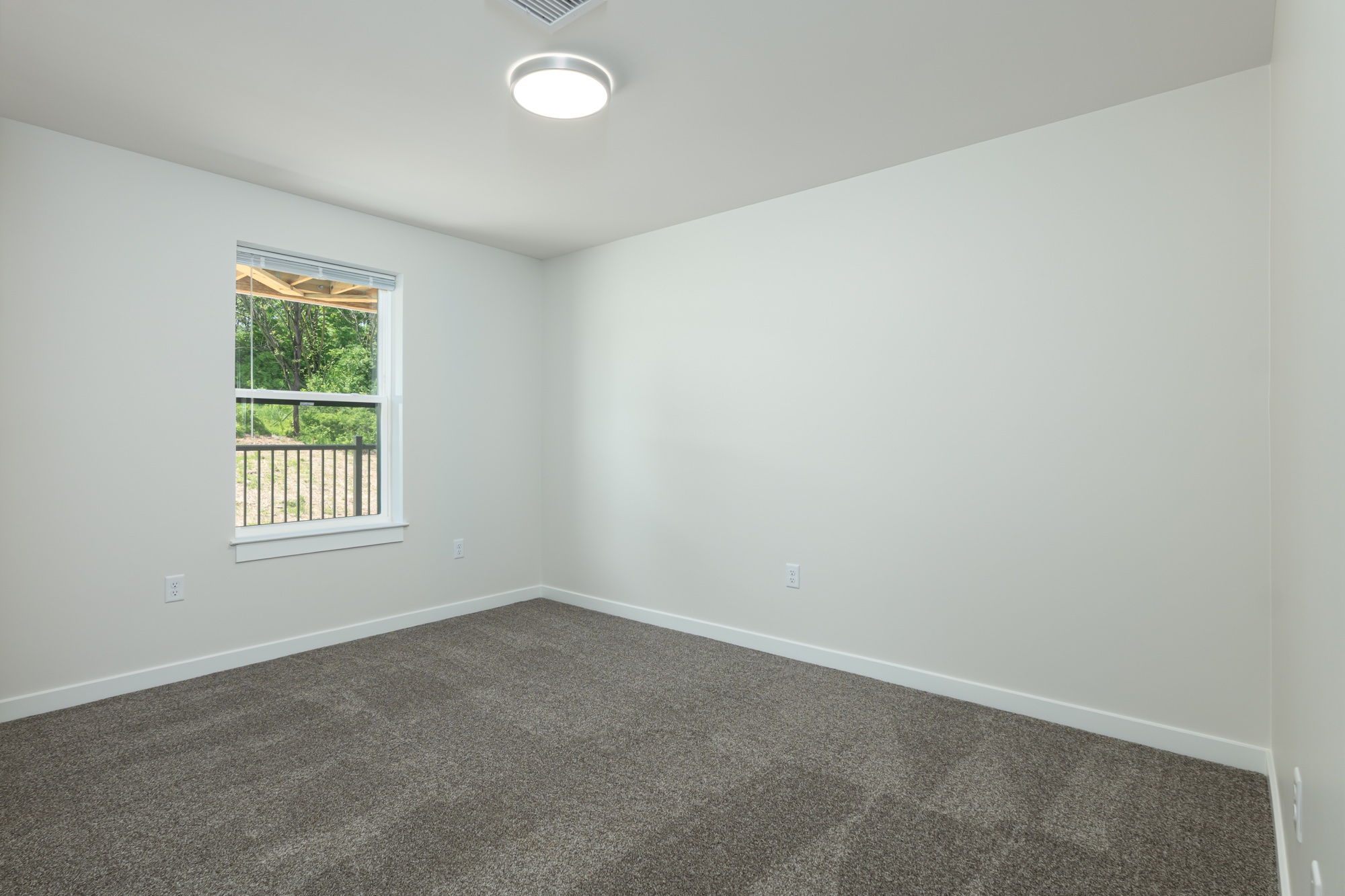 Empty spare bedroom at Weldon Place before virtual staging
