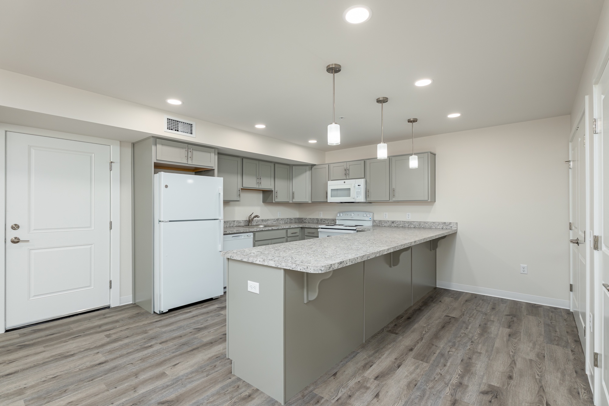 Empty two-bedroom kitchen at Weldon Place before virtual staging