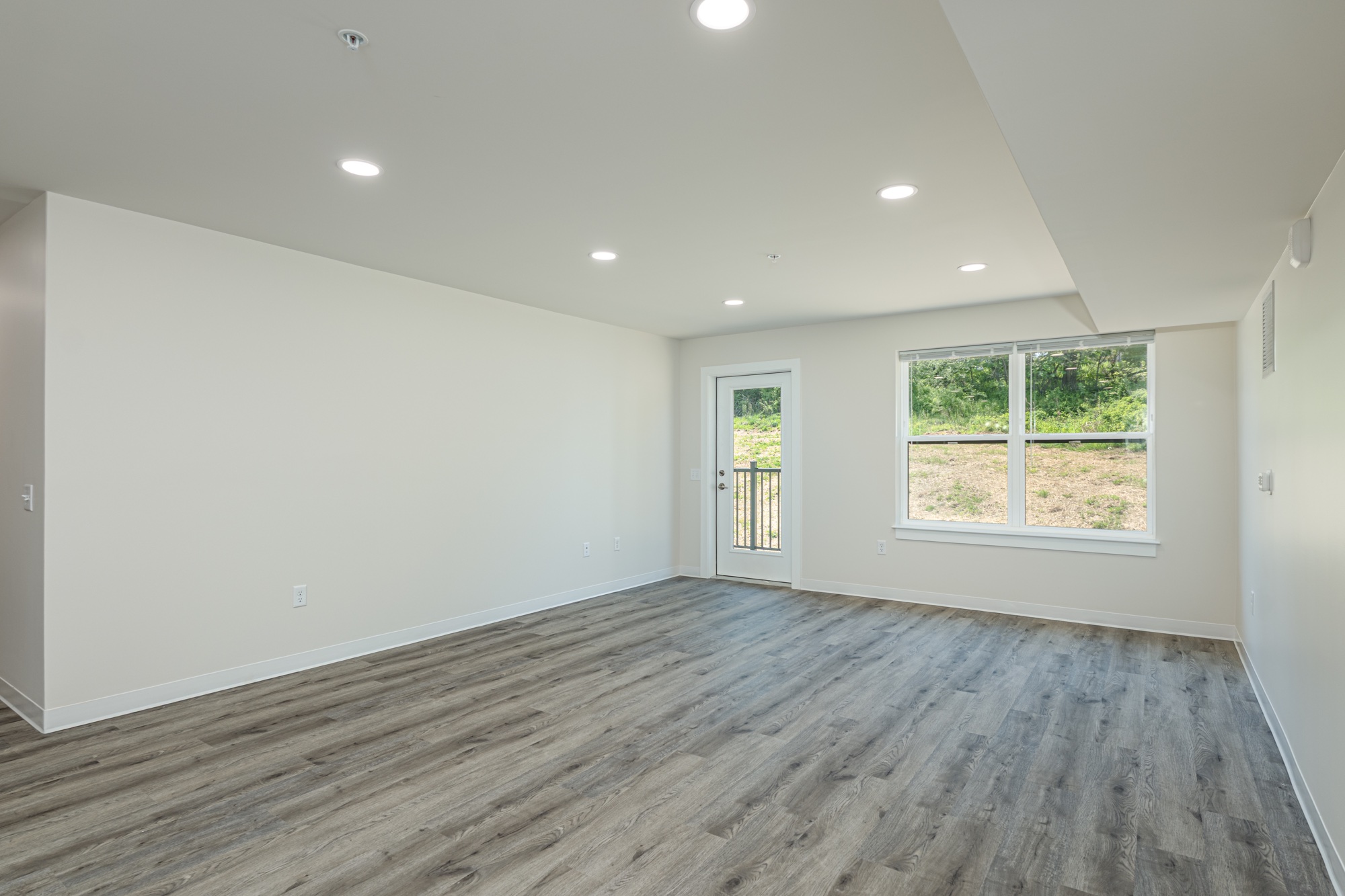 Empty two-bedroom living room at Weldon Place before virtual staging